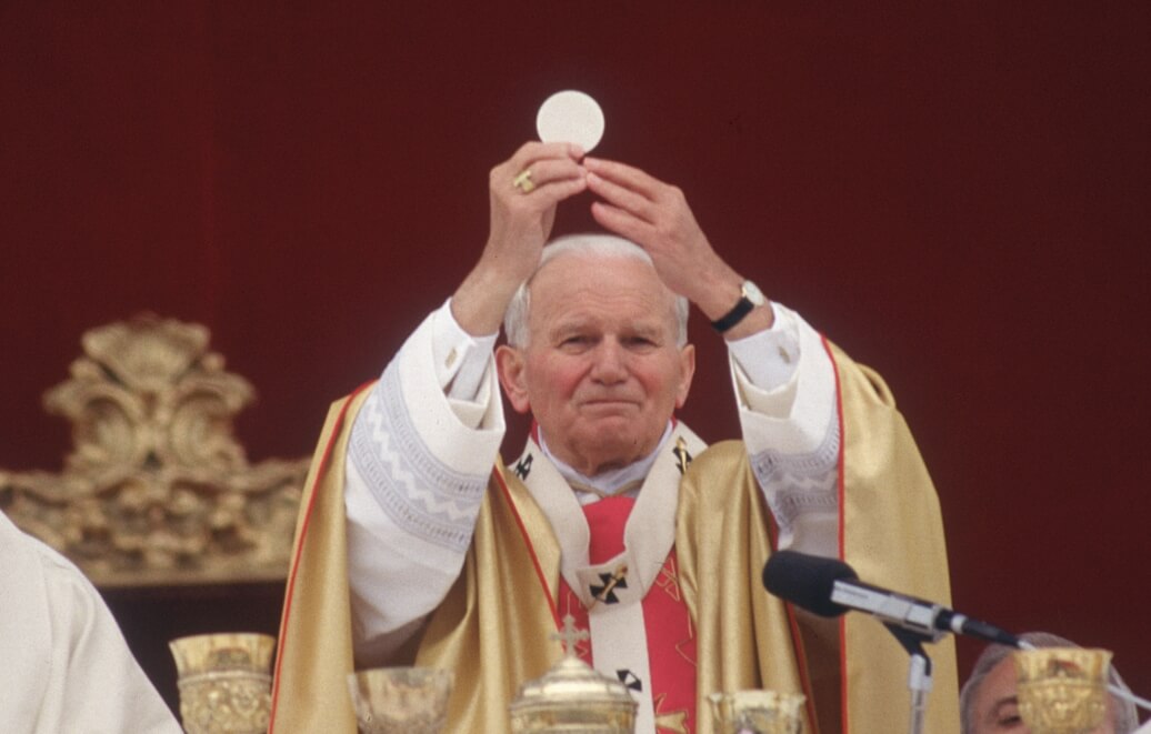 Image of Pope John Paul the second raising the host during the Eucharist.